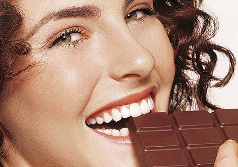Chocolate: Guloseima de Páscoa Mulher comendo chocolate